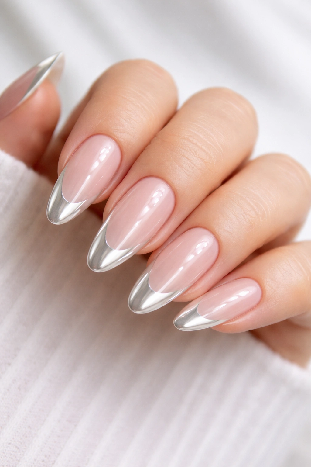 Almond nails with pink base and white chrome tips