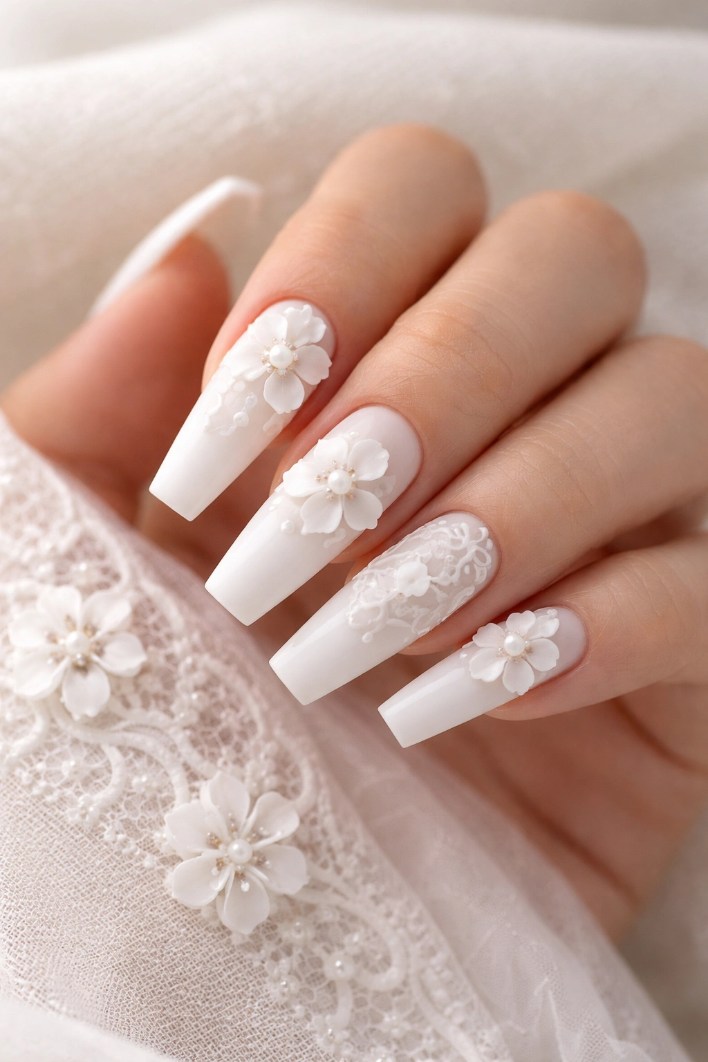 White-on-white coffin nails with lace detailing and sculpted flowers.