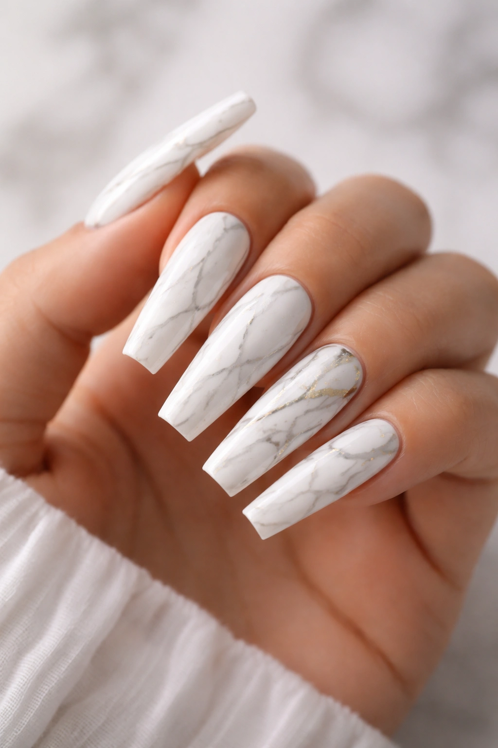 Close-up of white marble coffin nails with fine gray veining