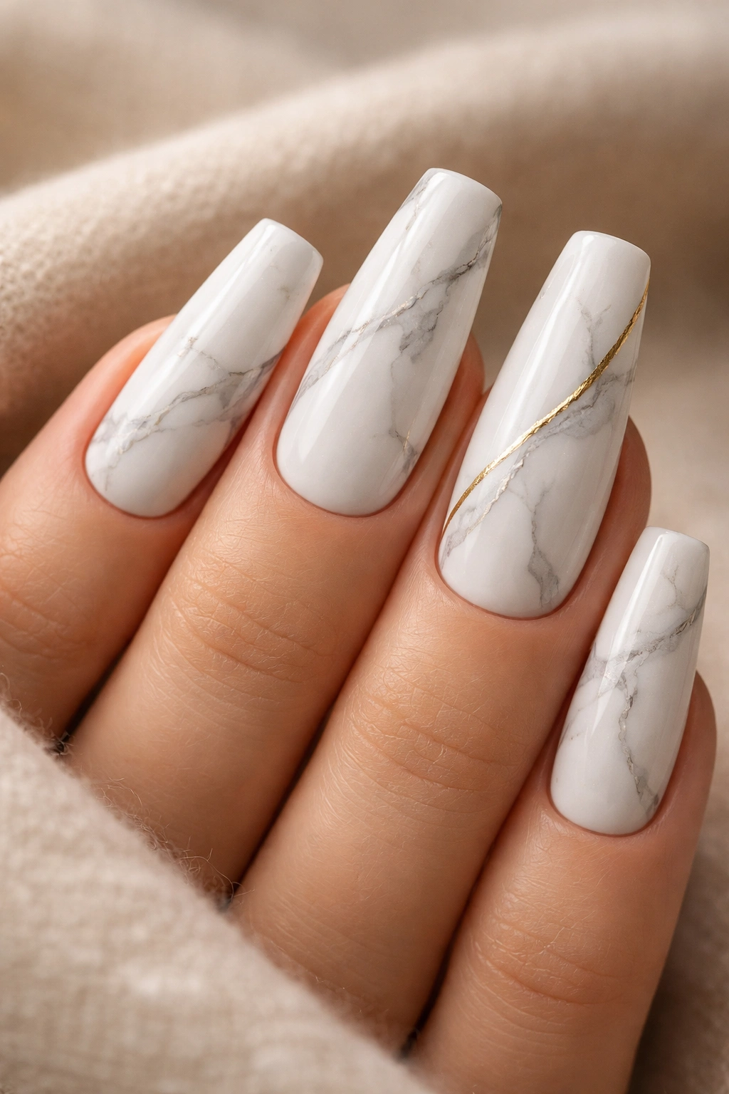 Close-up of white marble coffin nails with fine grey veins and a thin gold line
