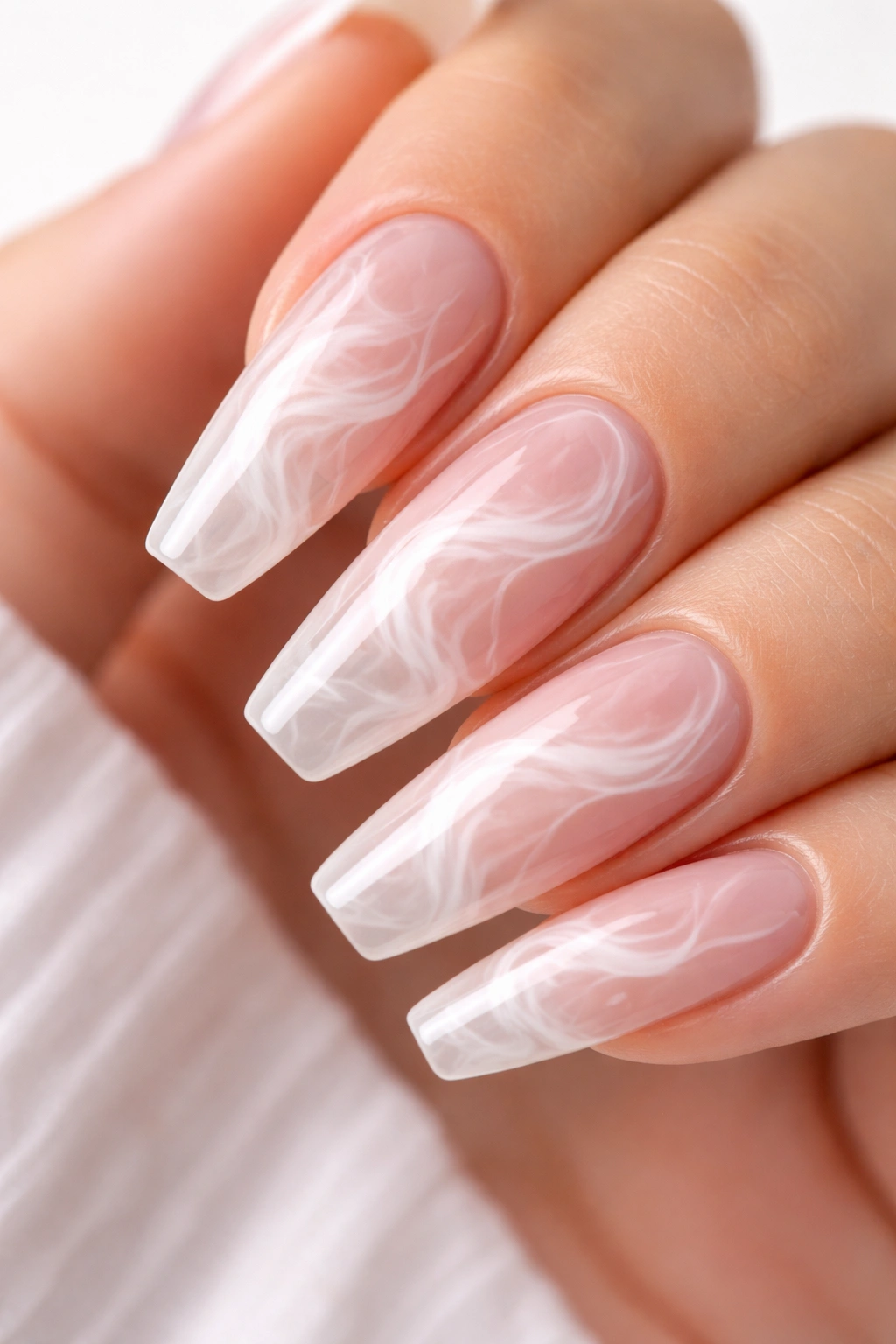 Nail with white smoke swirls on a clear base