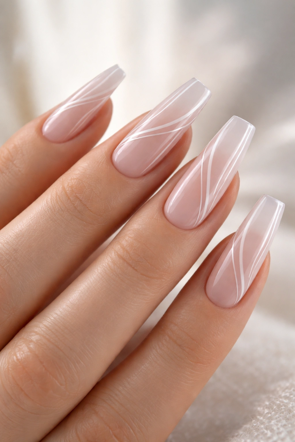 Coffin nails with thin white swirl lines on sheer base