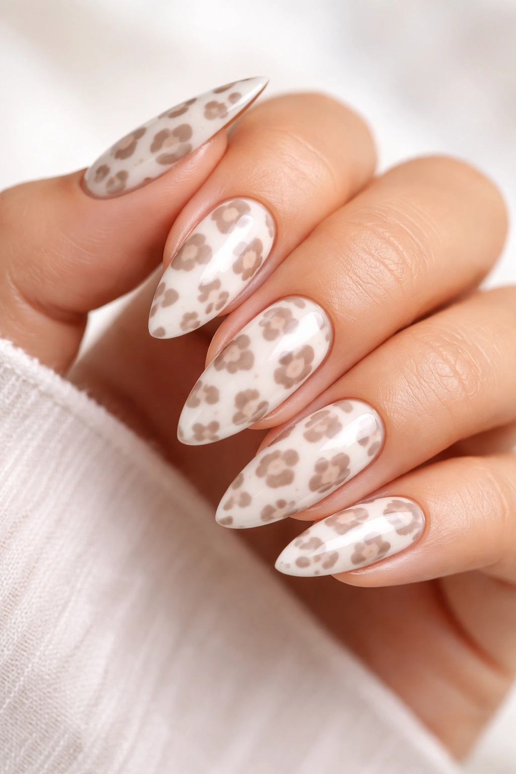 White and taupe leopard on almond nails for a bright, clean look.