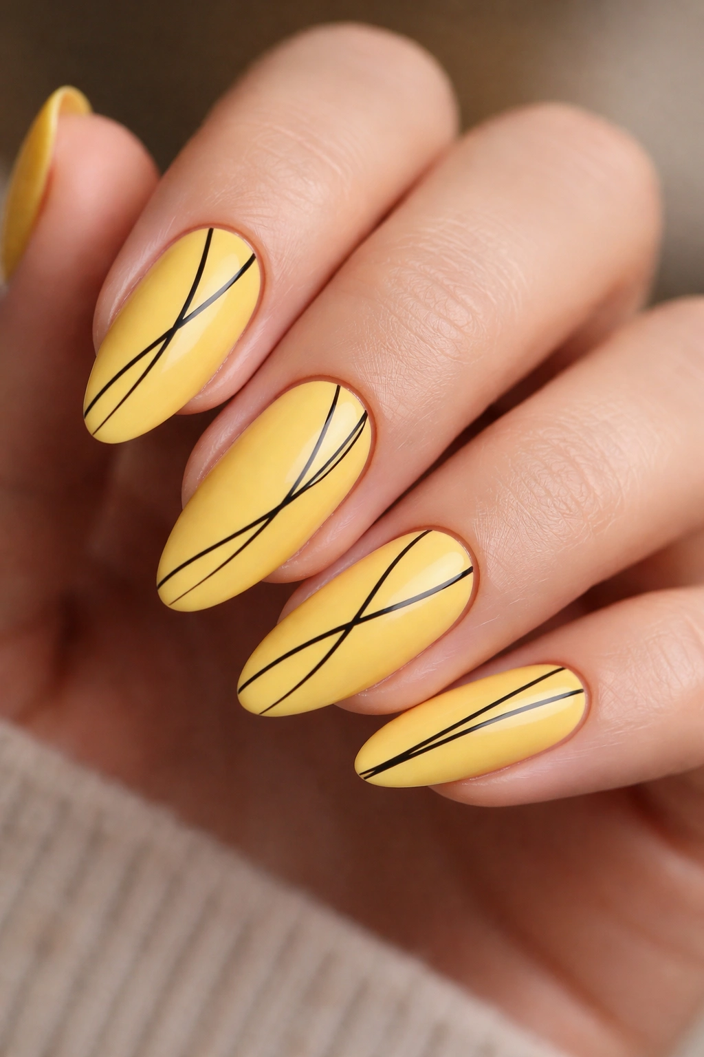 Almond nails with yellow base and thin black line art