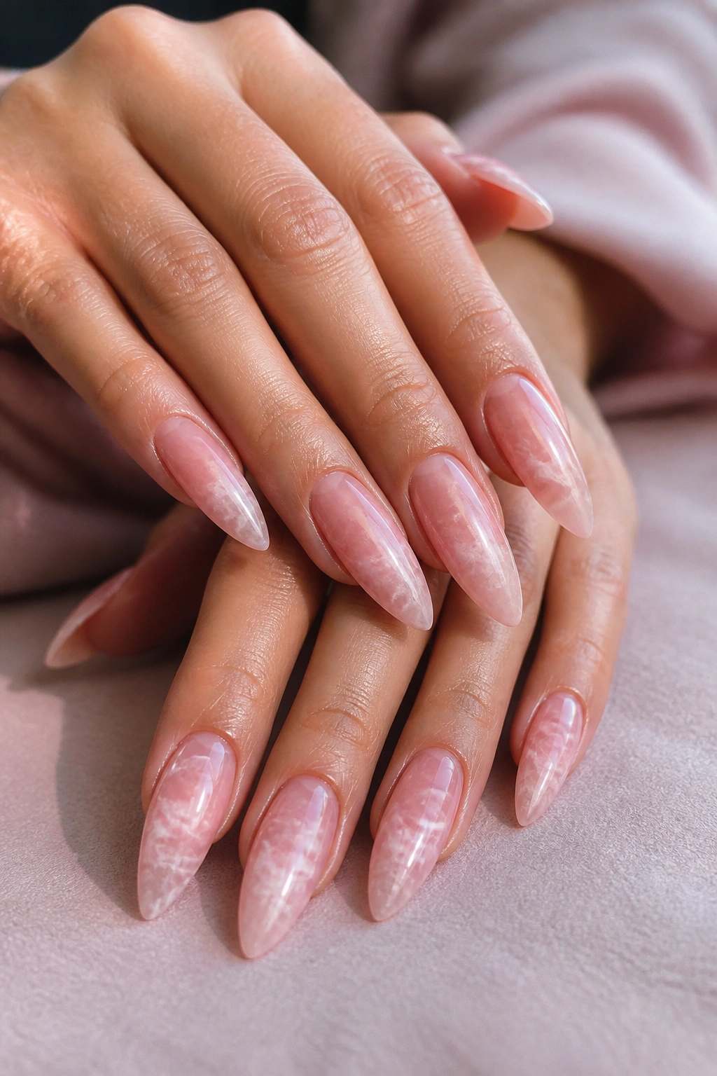 Close-up of rose quartz marble almond nails on a real hand