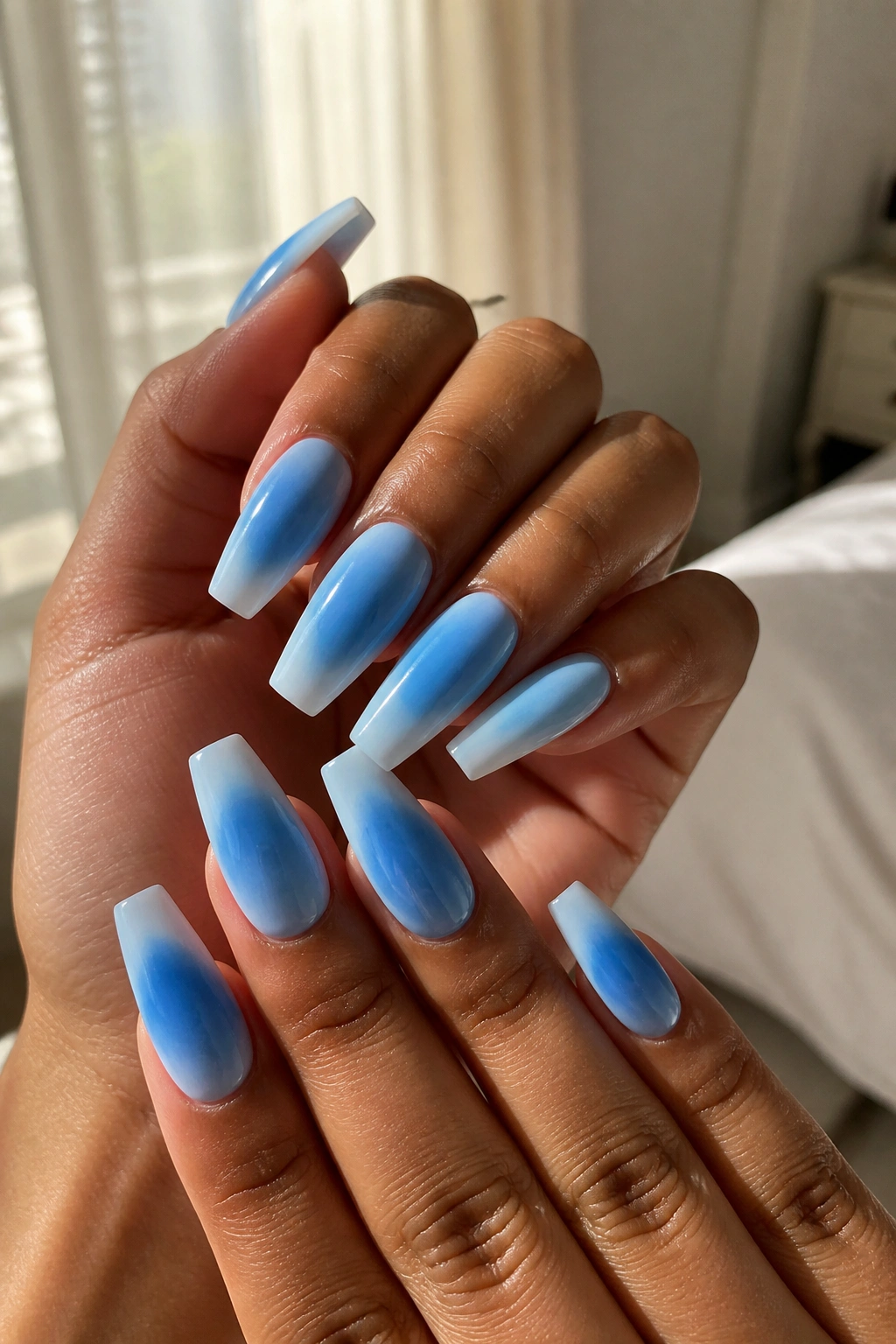Close-up of deep-to-light blue aura nails with center glow fading to edges