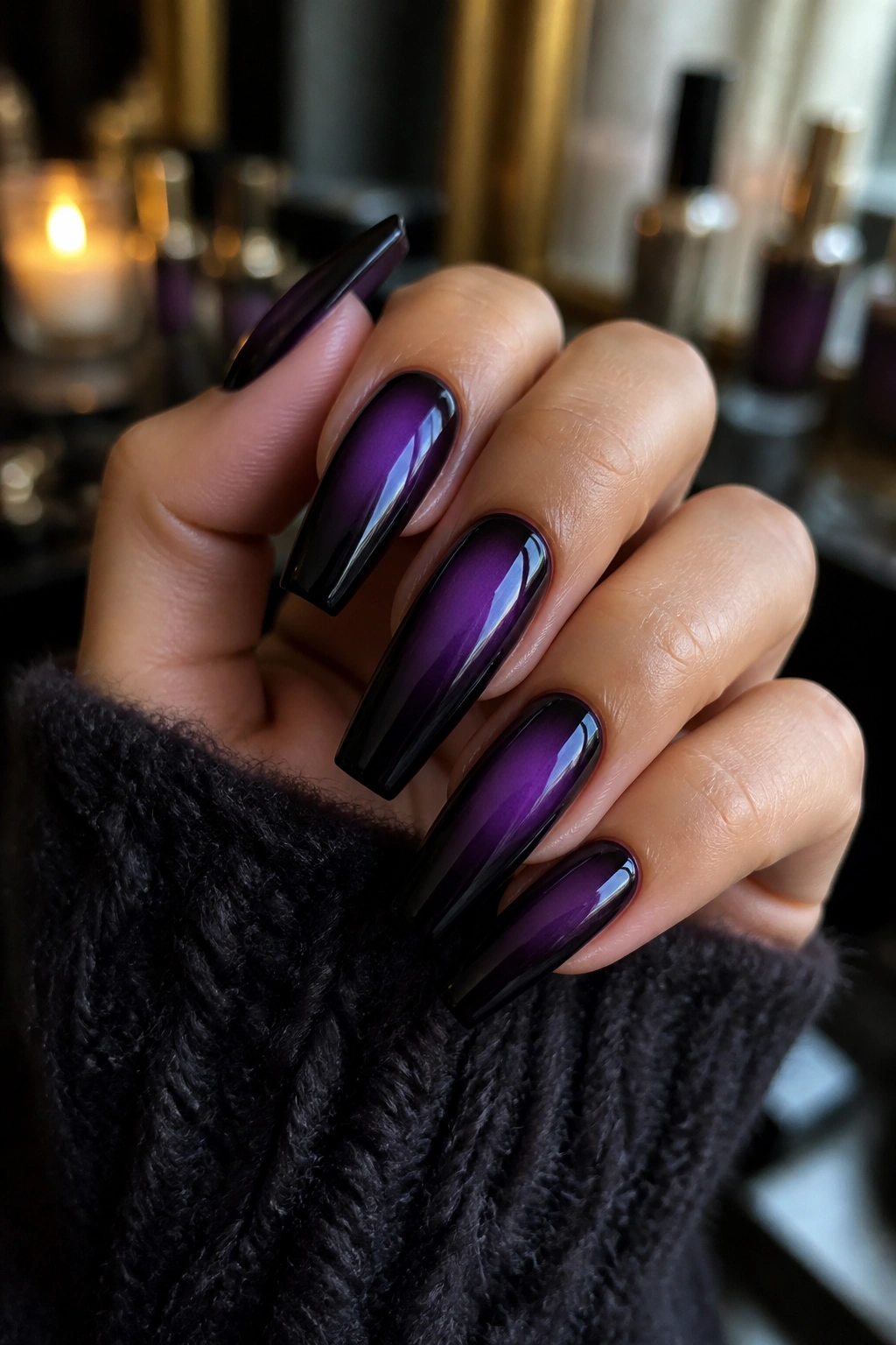 Close-up of purple-to-black aura coffin nails on a real hand with a glossy finish