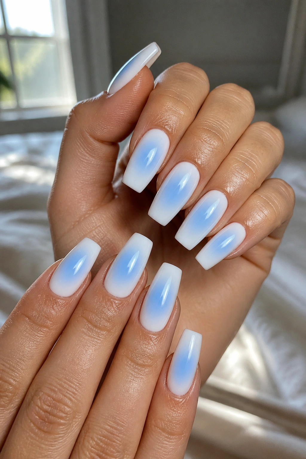 Milky white coffin nails with centered baby-blue aura glow