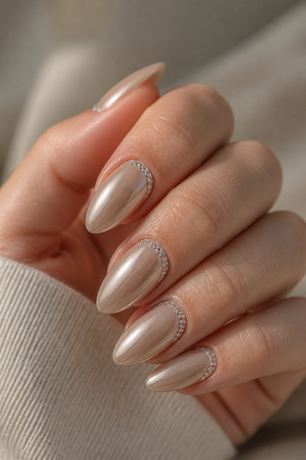 Beige chrome nails with tiny rhinestone arc