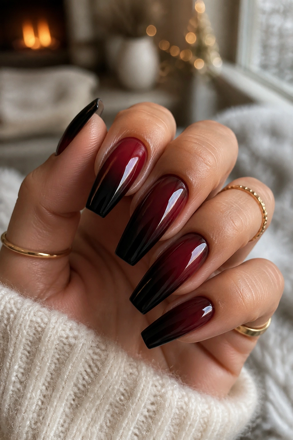 Close-up of long coffin nails with black cherry to onyx gradient on a real hand.