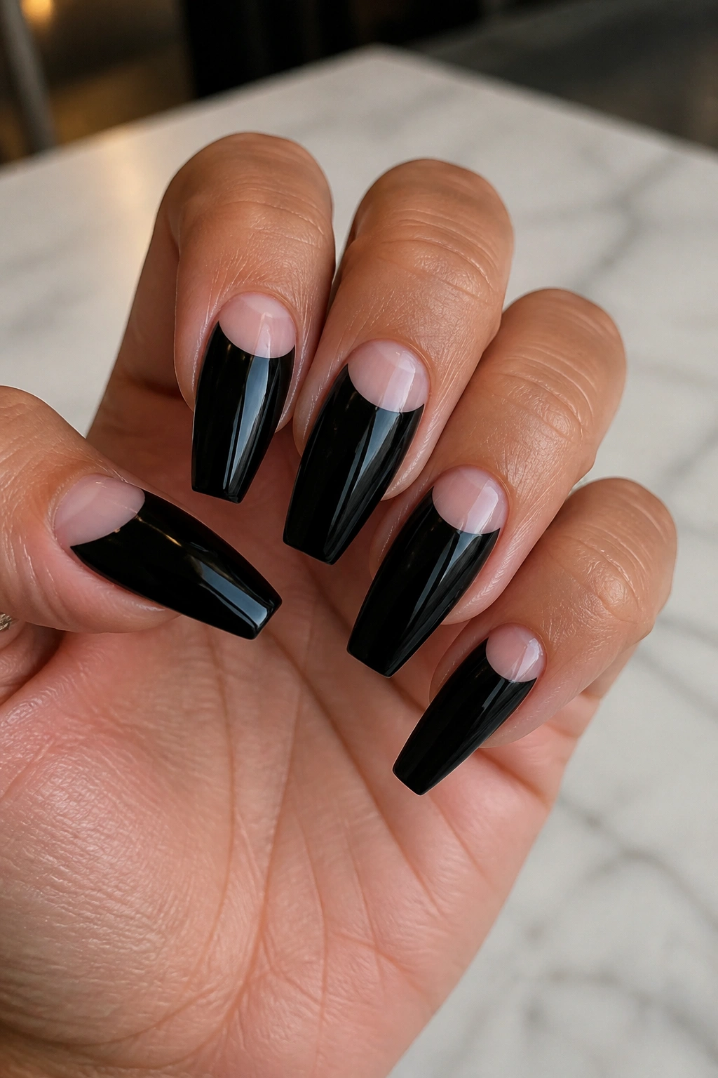 Coffin nails with black polish and bare half-moon near cuticle
