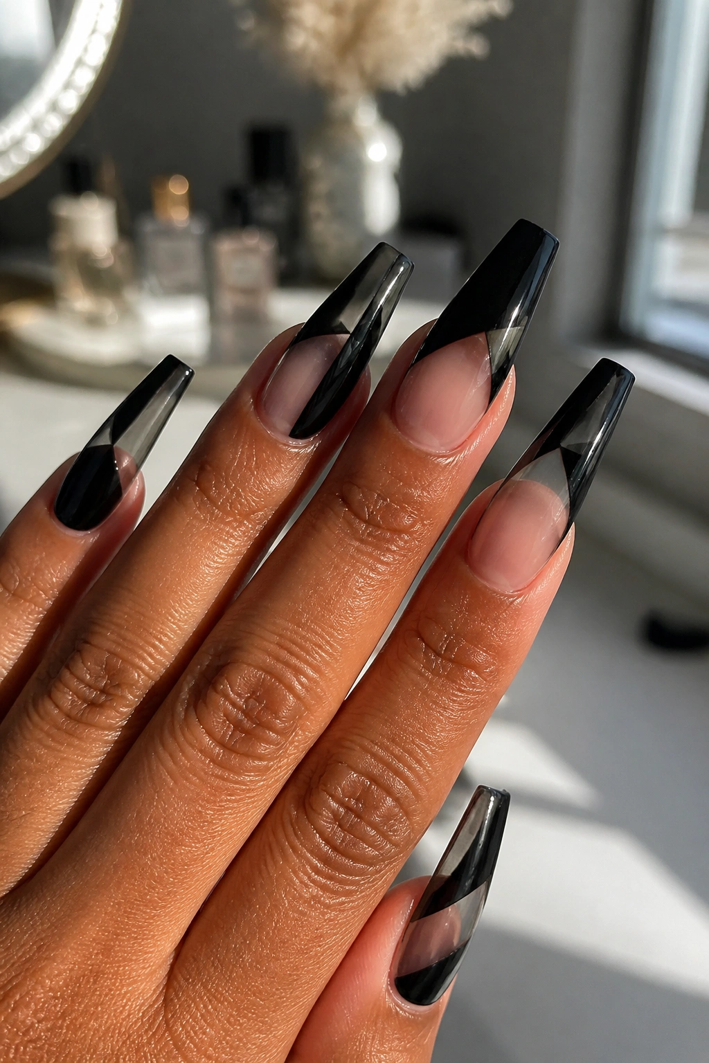 Close-up of black and clear window coffin nails on a real hand