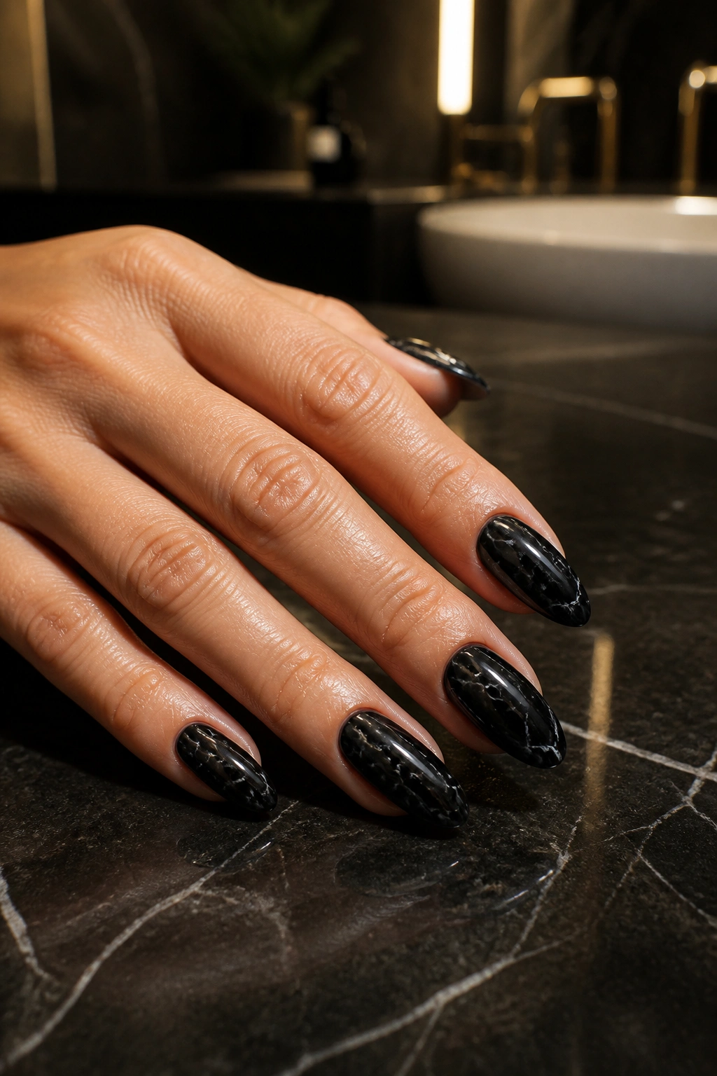 Almond nails featuring black marble with white lines on a real hand
