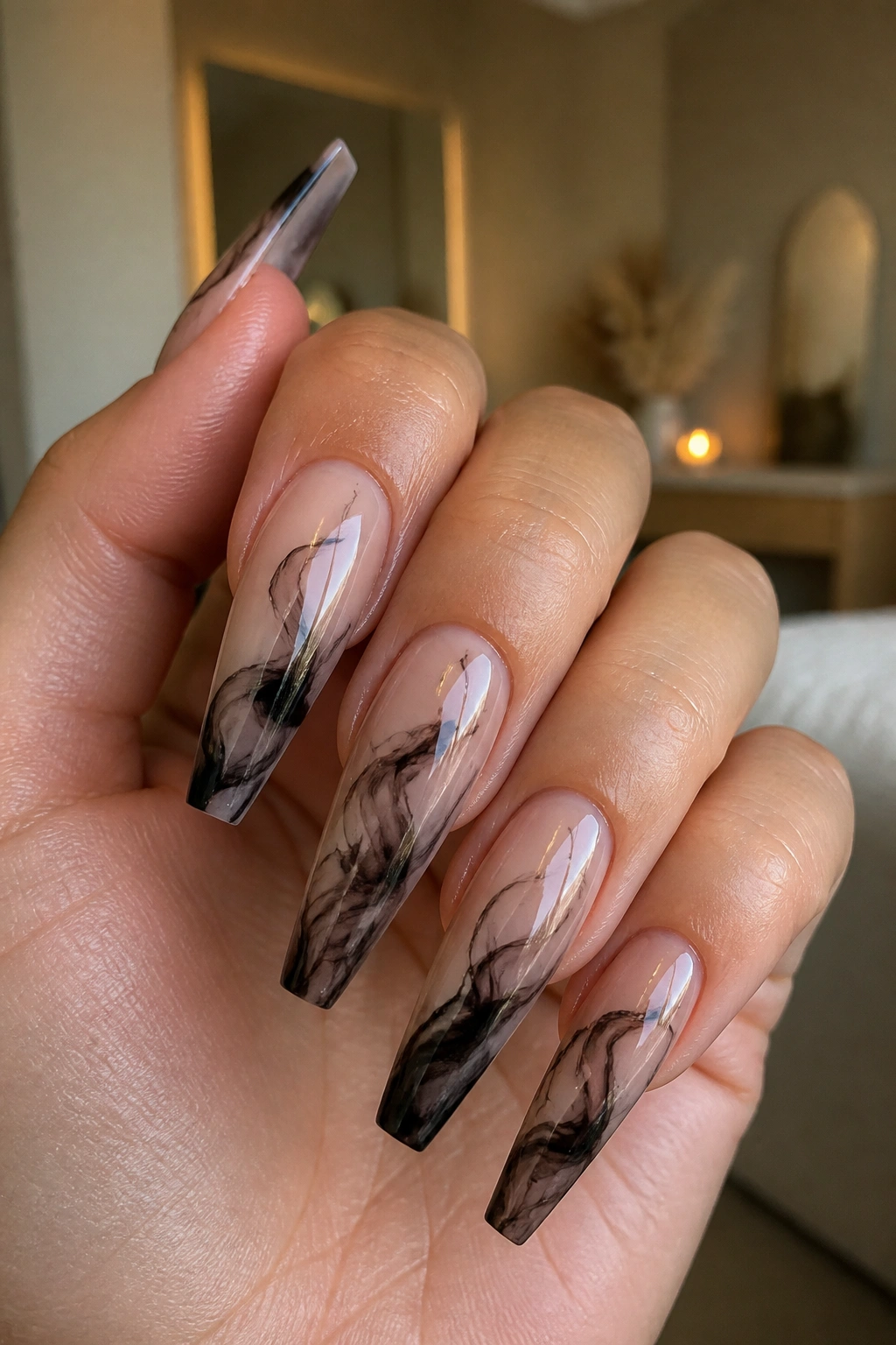 Close-up of black smoke marble on coffin nails with nude base.