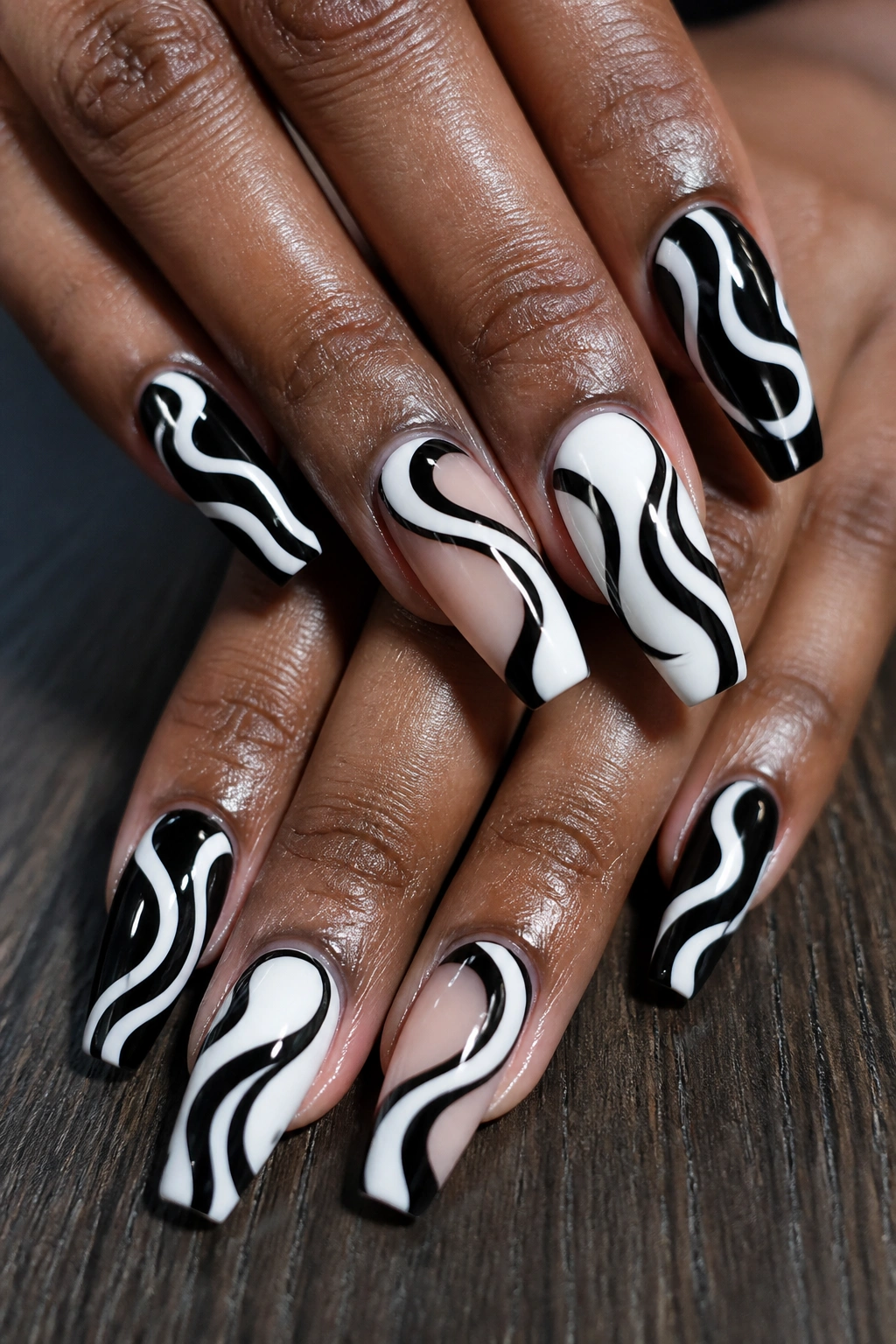 Close-up of real hands with black and white mod swirls on coffin nails