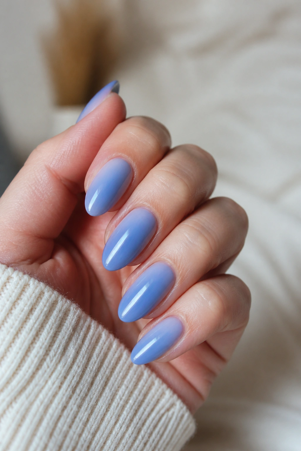 Almond nails with blue aura glow fading outward