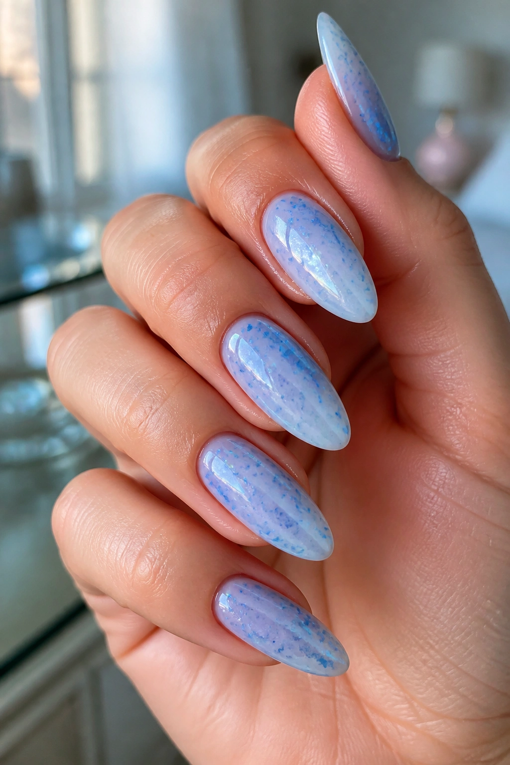 Almond nails with blue milk bath shimmer on milky base