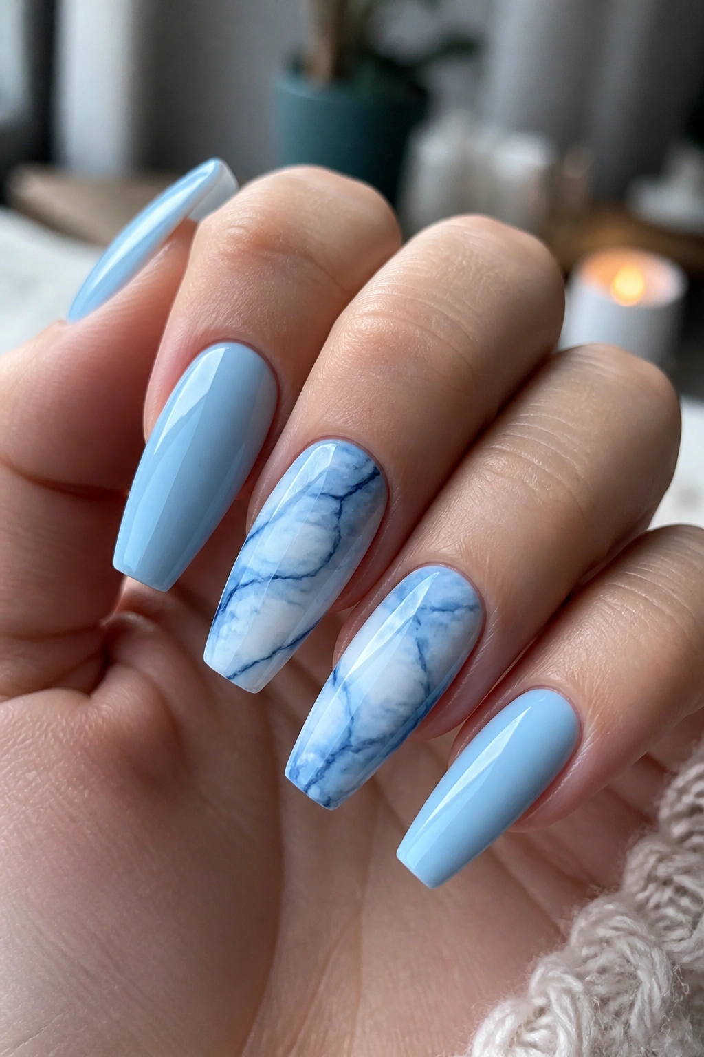 Close-up of real hand with blue and white marble coffin nails