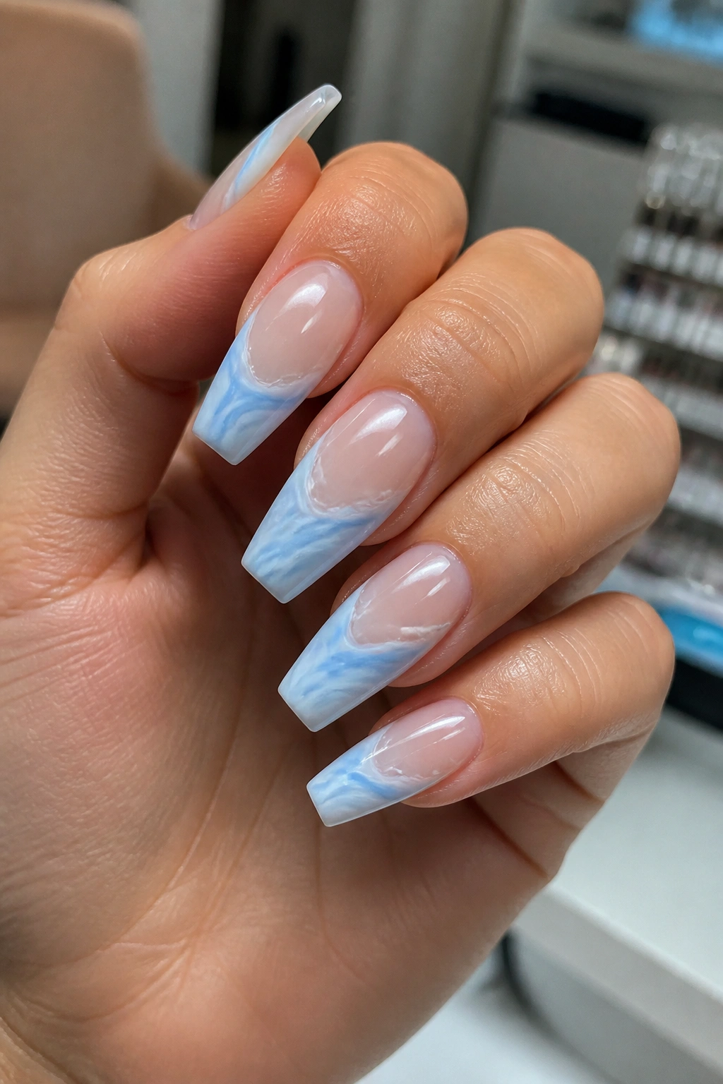 Close-up of coffin nails with blue and white marble swirl patterns