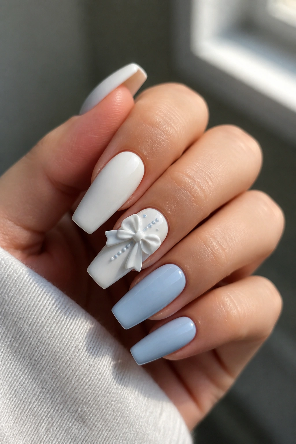 Nail with White 3D bow and blue pearls on accent nail