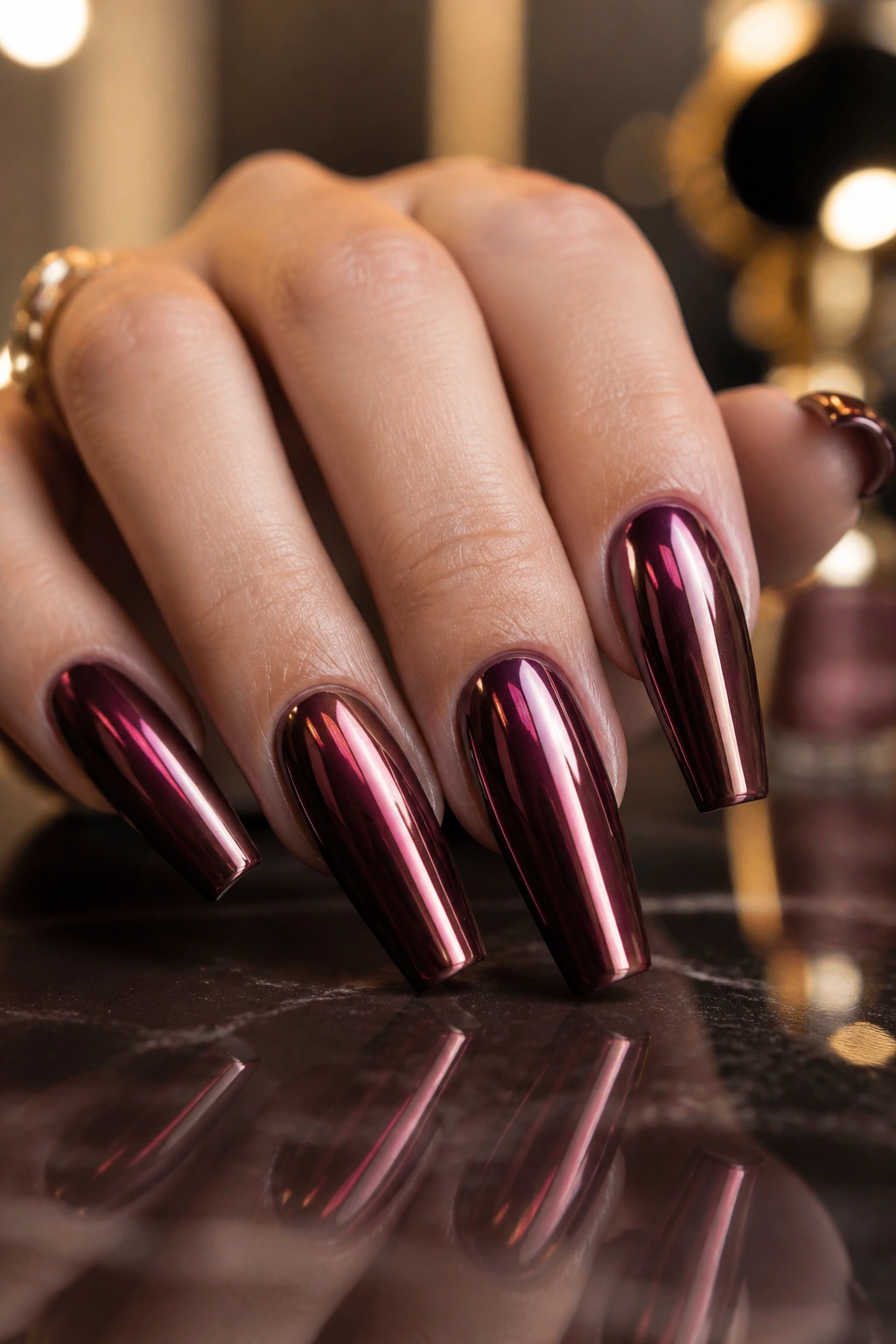 Close-up Cabernet Chrome burgundy coffin nails on a real hand