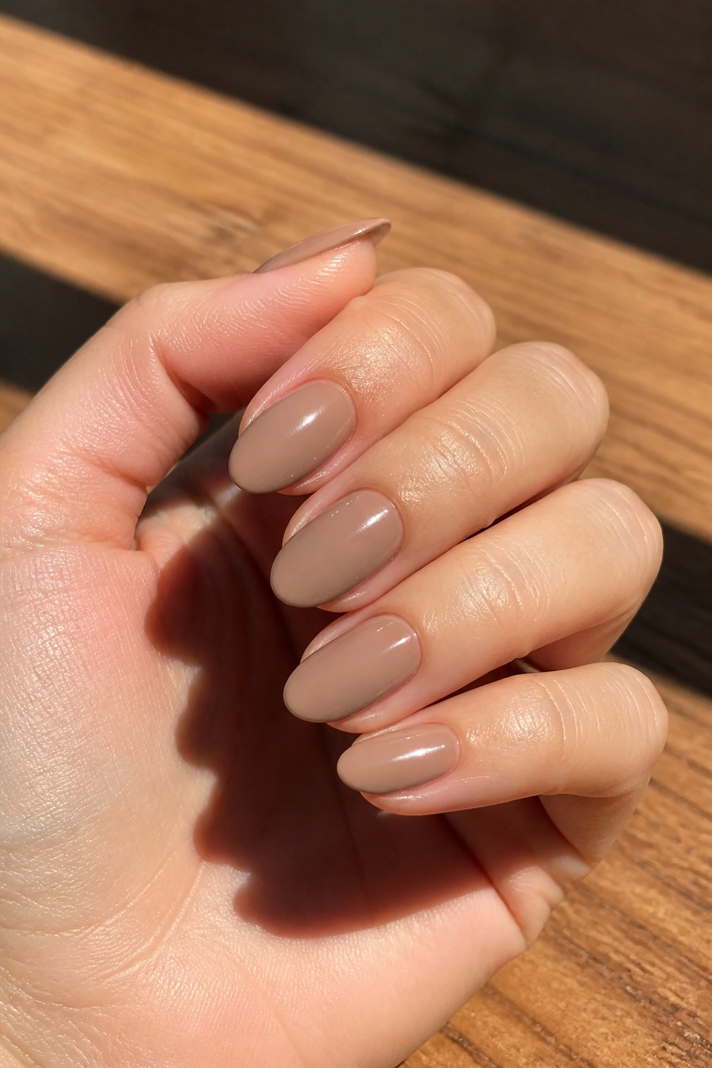 Close-up of cappuccino nude almond nails on real hand