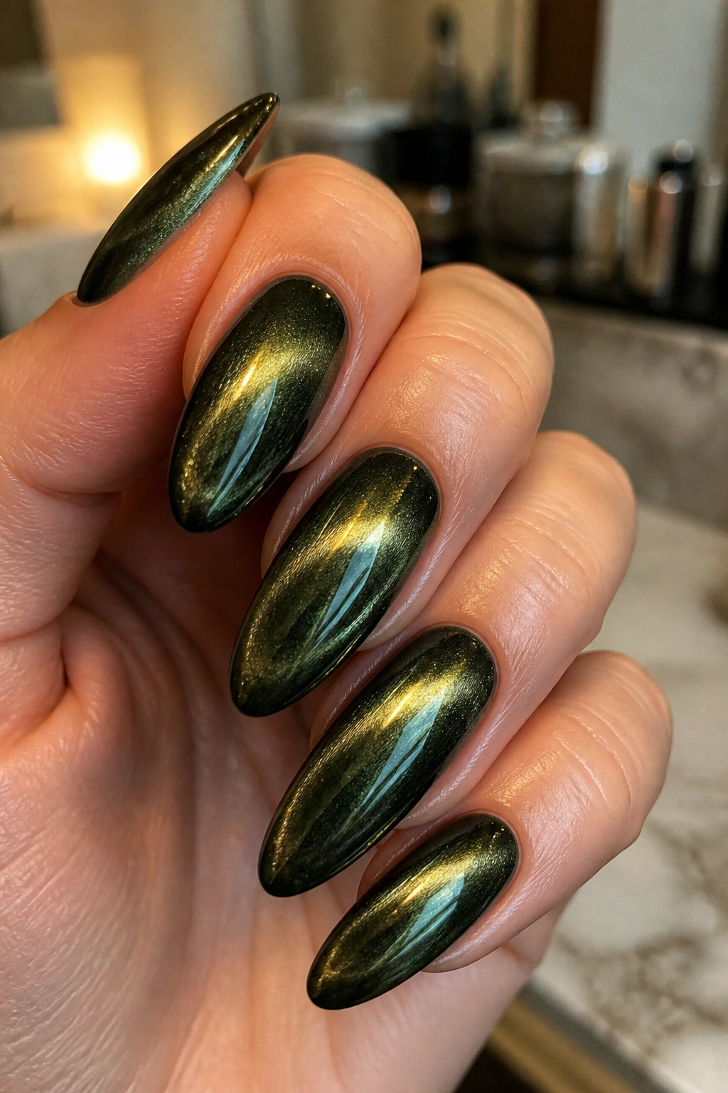Close-up of a real hand showing cat-eye almond nails with shifting color bands.