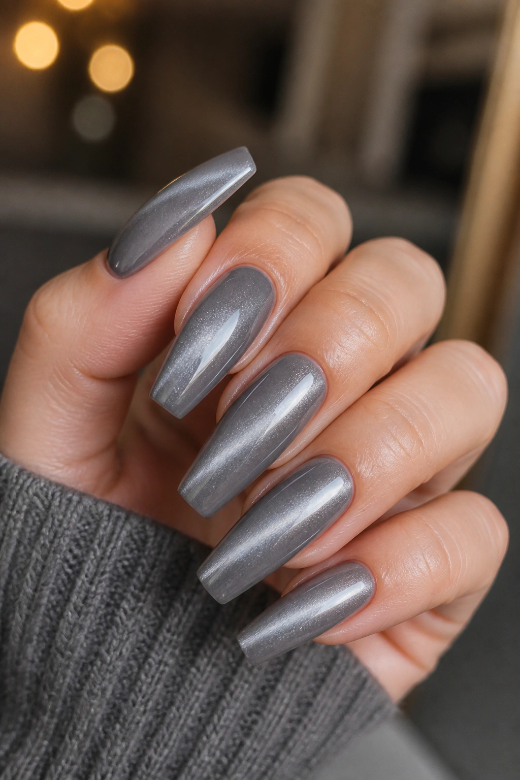 Close-up of soft grey cat-eye velvet nails showing a moving light band.