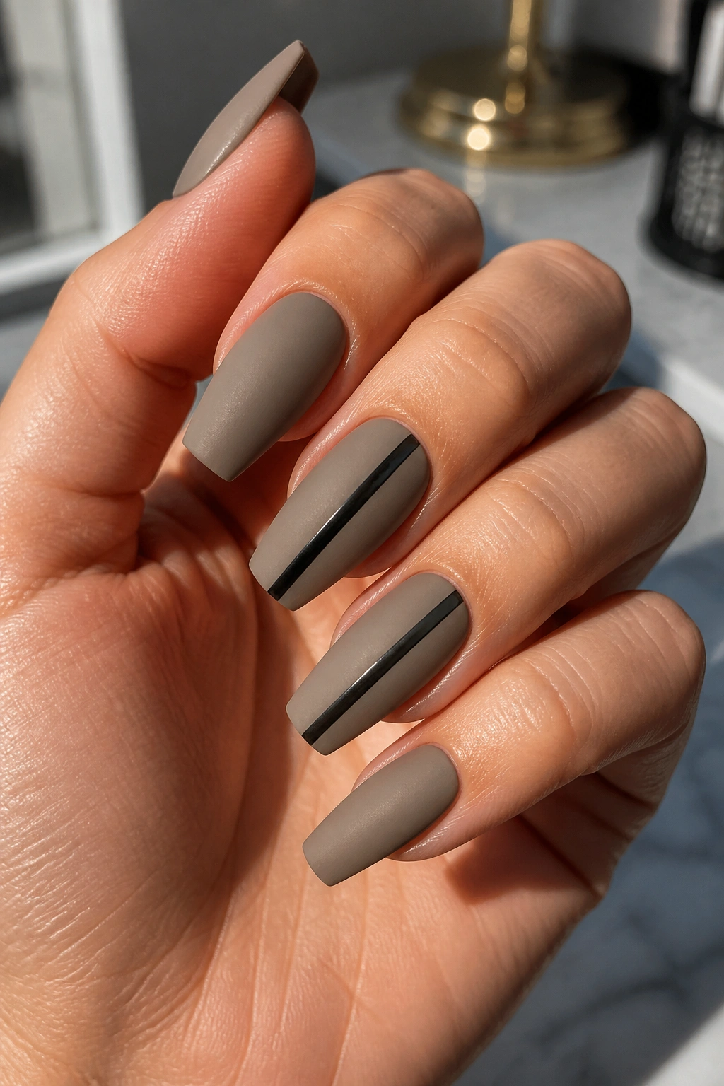 Cement grey nails with a black stripe