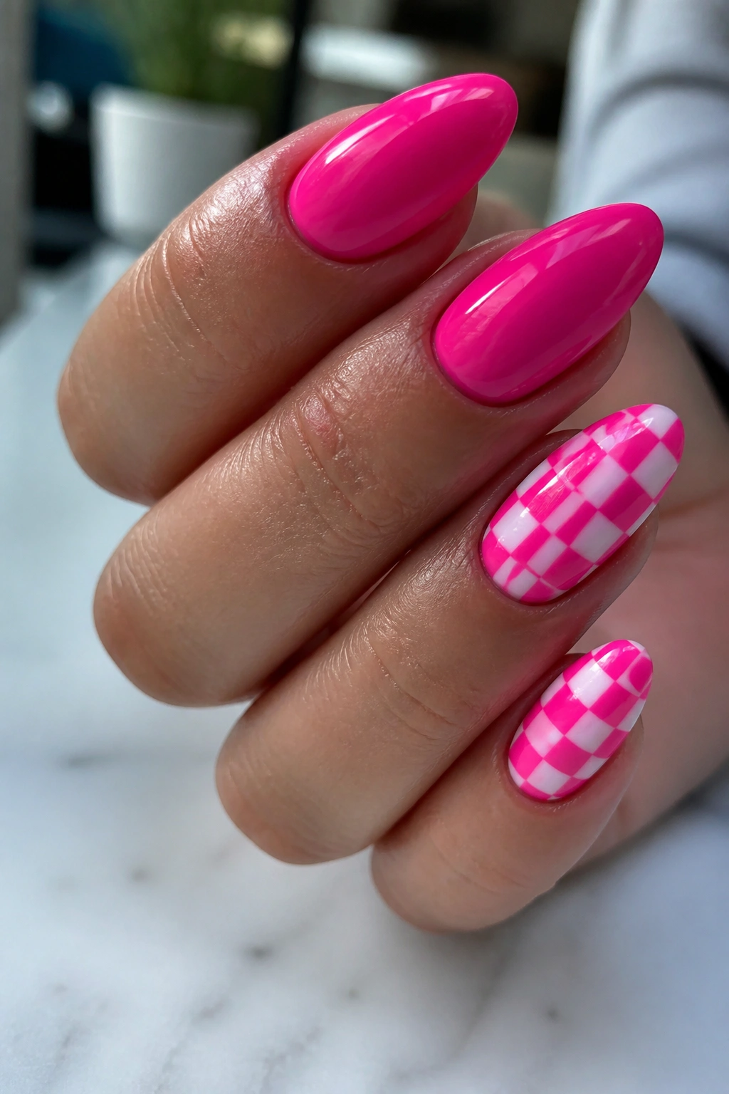 Close-up of checkerboard accent almond nails on a real hand