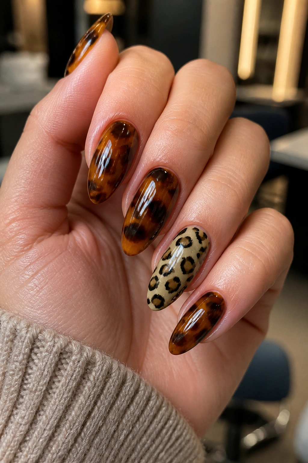 Close-up of almond nails with cheetah print and tortoiseshell mix