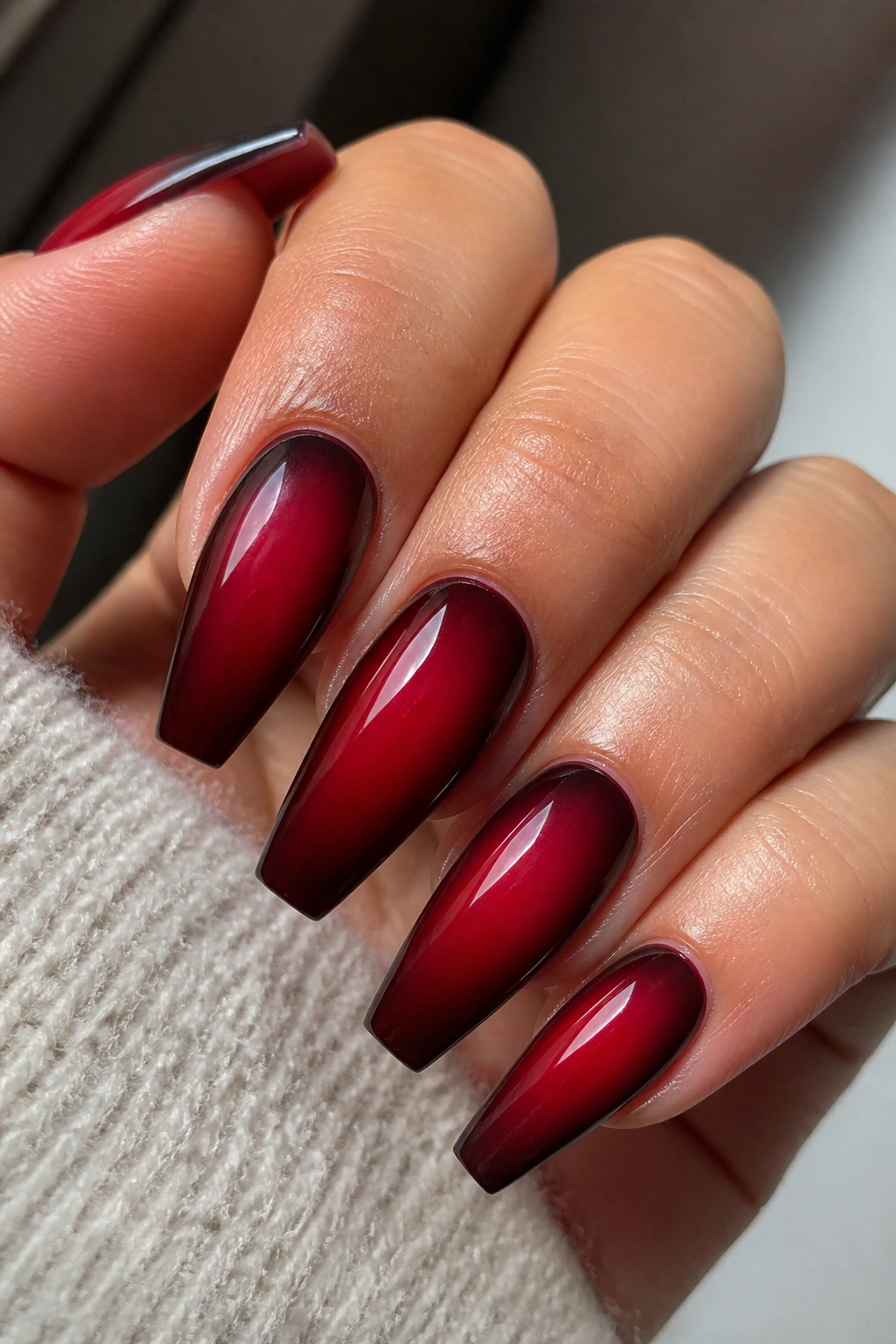 Coffin nails with a cherry red aura gradient and darker halo near the edges