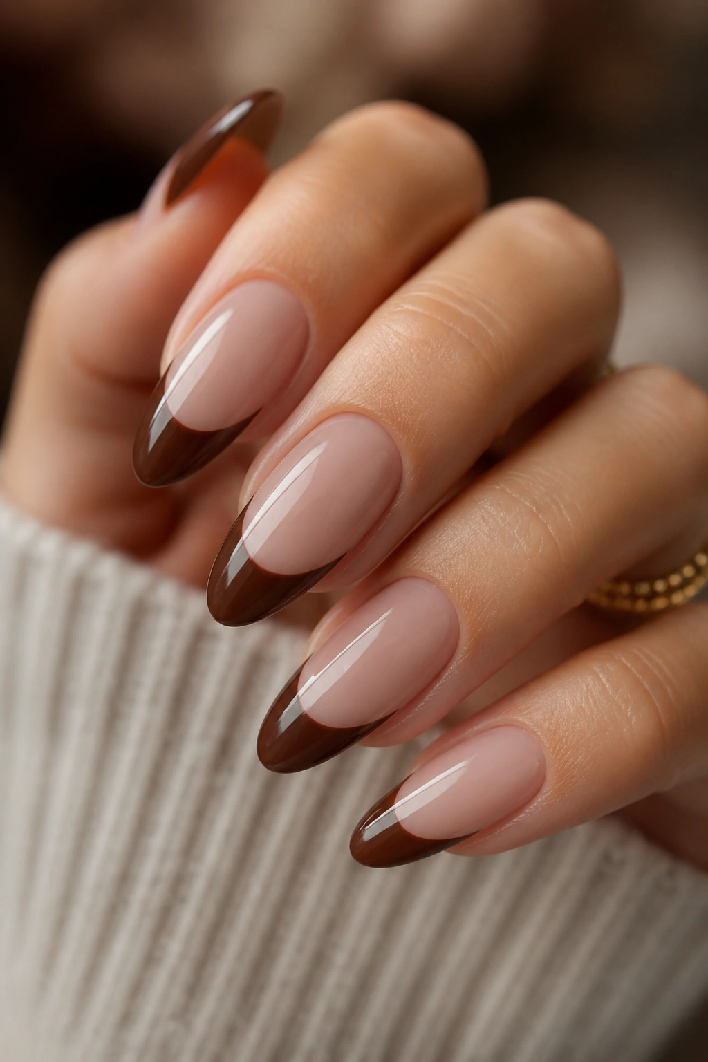 Almond nails with deep chestnut brown French tip on pale base