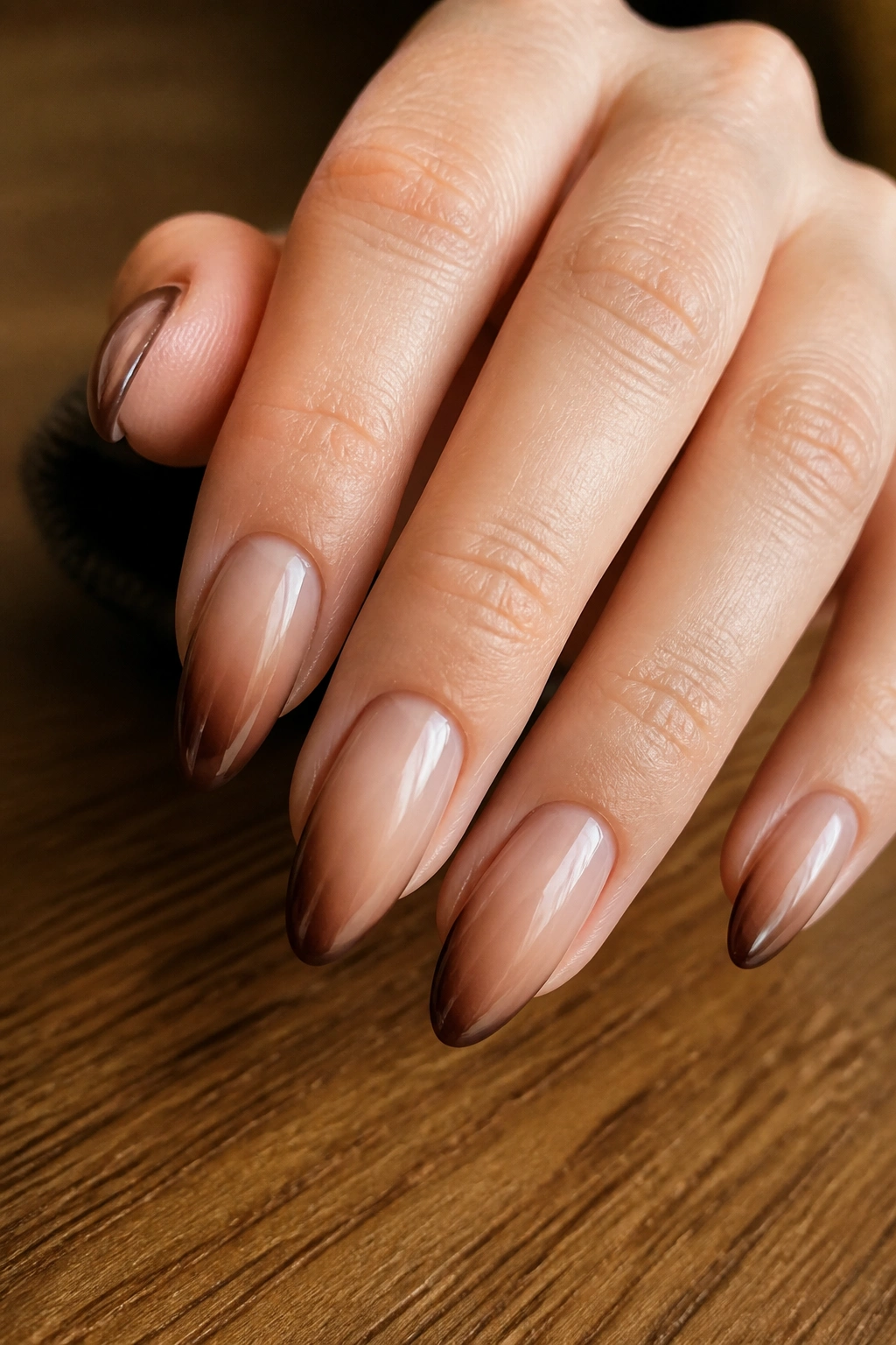 Almond nails with a chocolate-edged nude ombre.