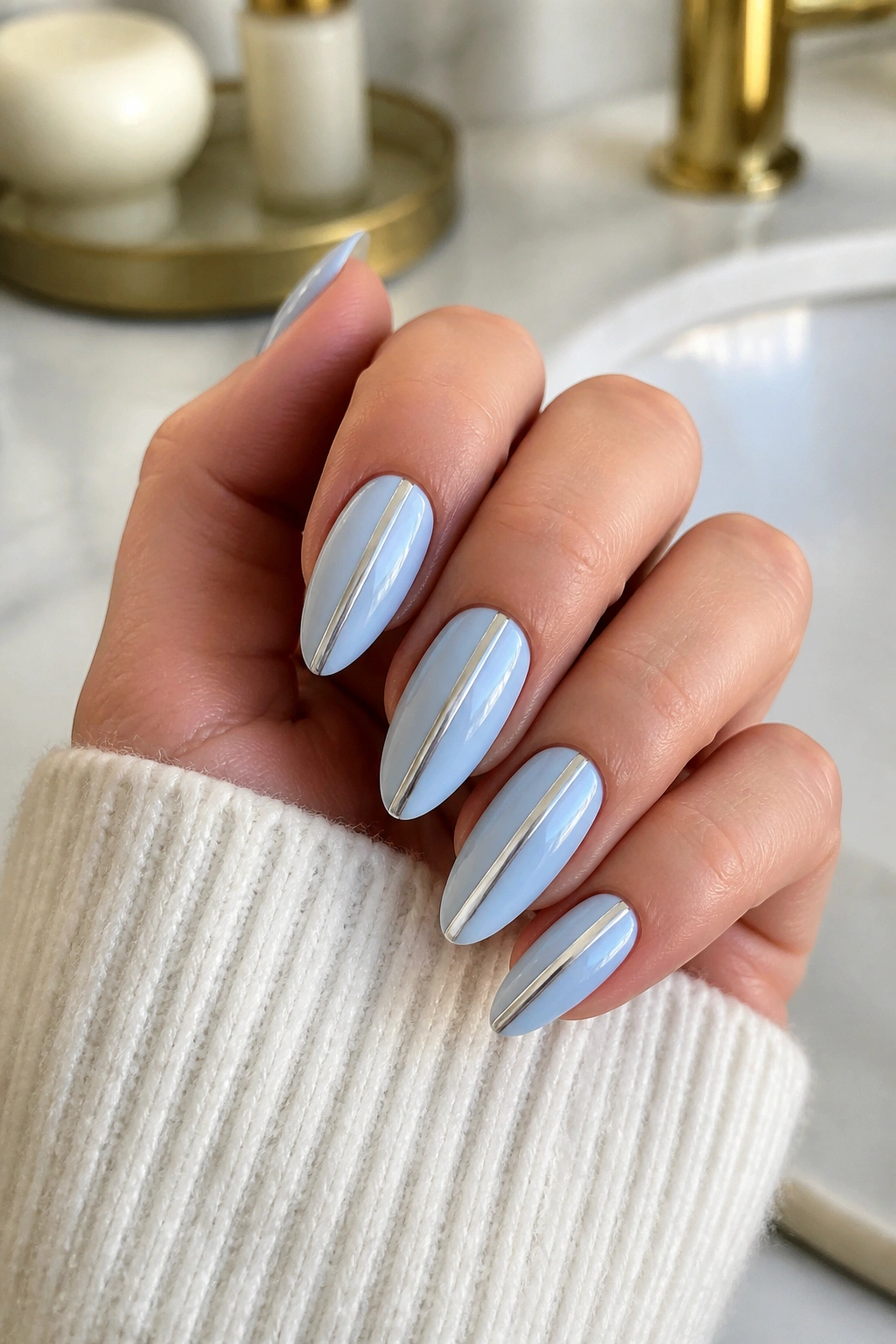 Almond nails with icy blue chrome stripe