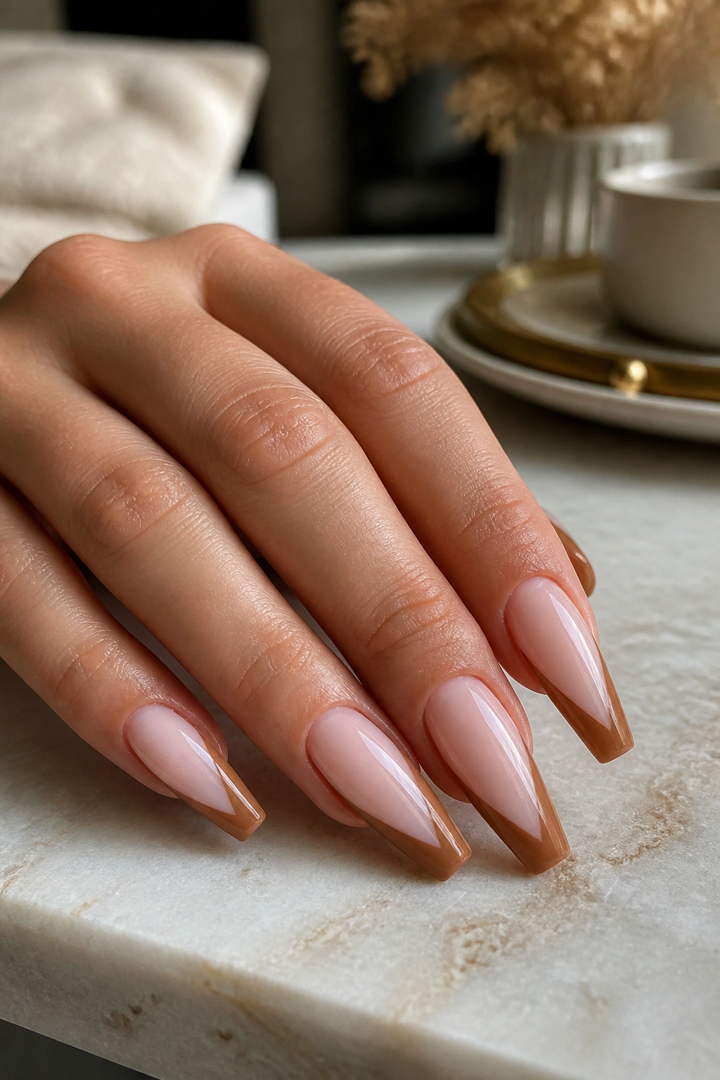 Close-up of cinnamon brown V-cut tips on coffin nails