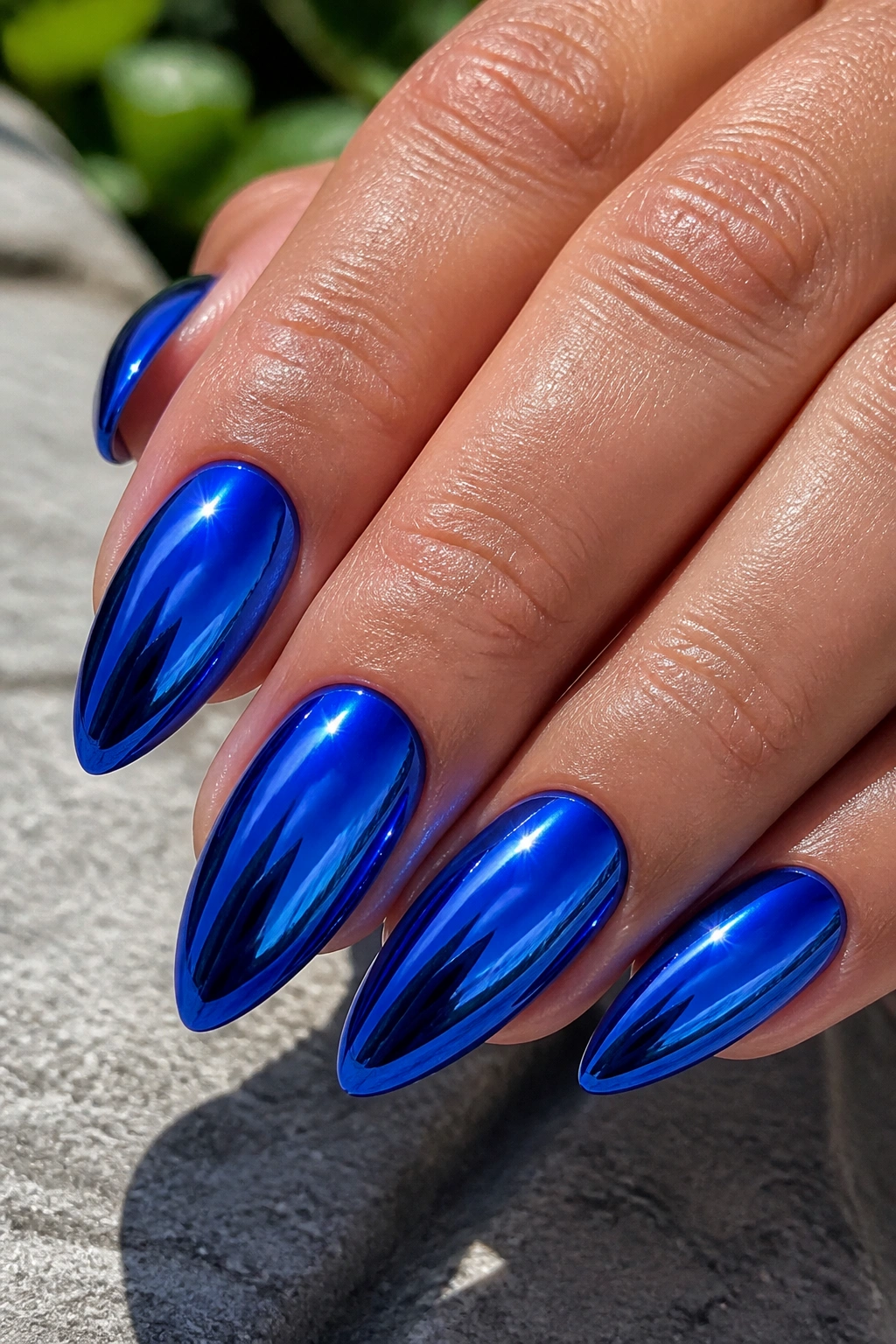 Close-up of cobalt chrome almond nails reflecting light