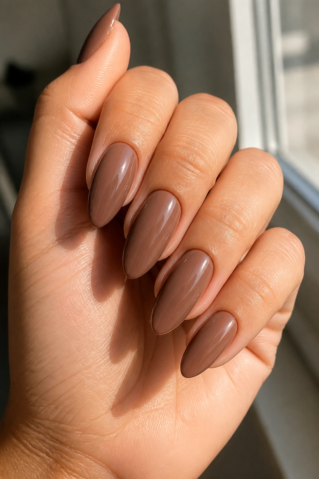 Almond nails in cocoa nude shade with glossy finish
