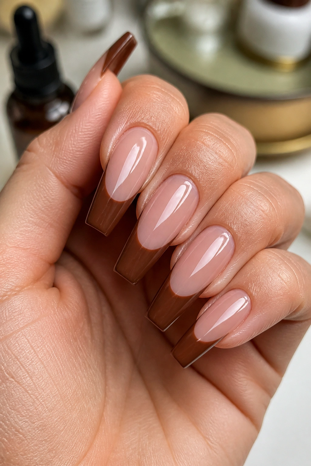 Close-up of crisp brown-tip coffin nails on real hand