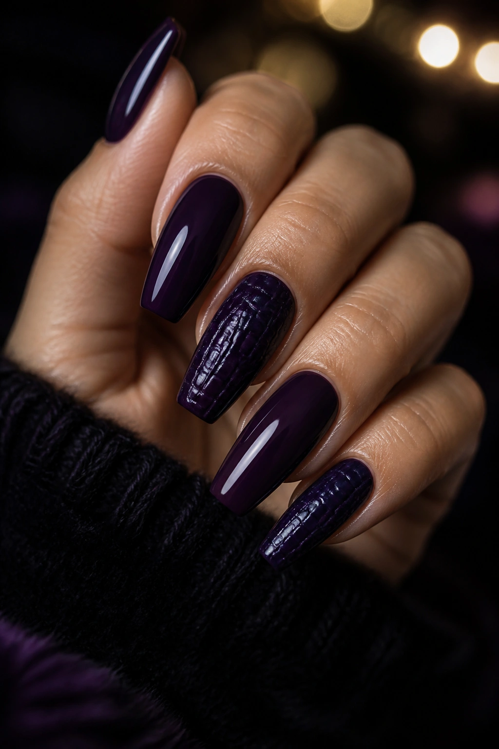 Close-up of dark violet croc-stamped coffin nails with glossy finish