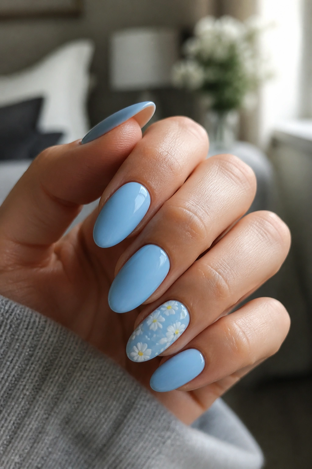 Almond nails with tiny white daisies accent on one nail