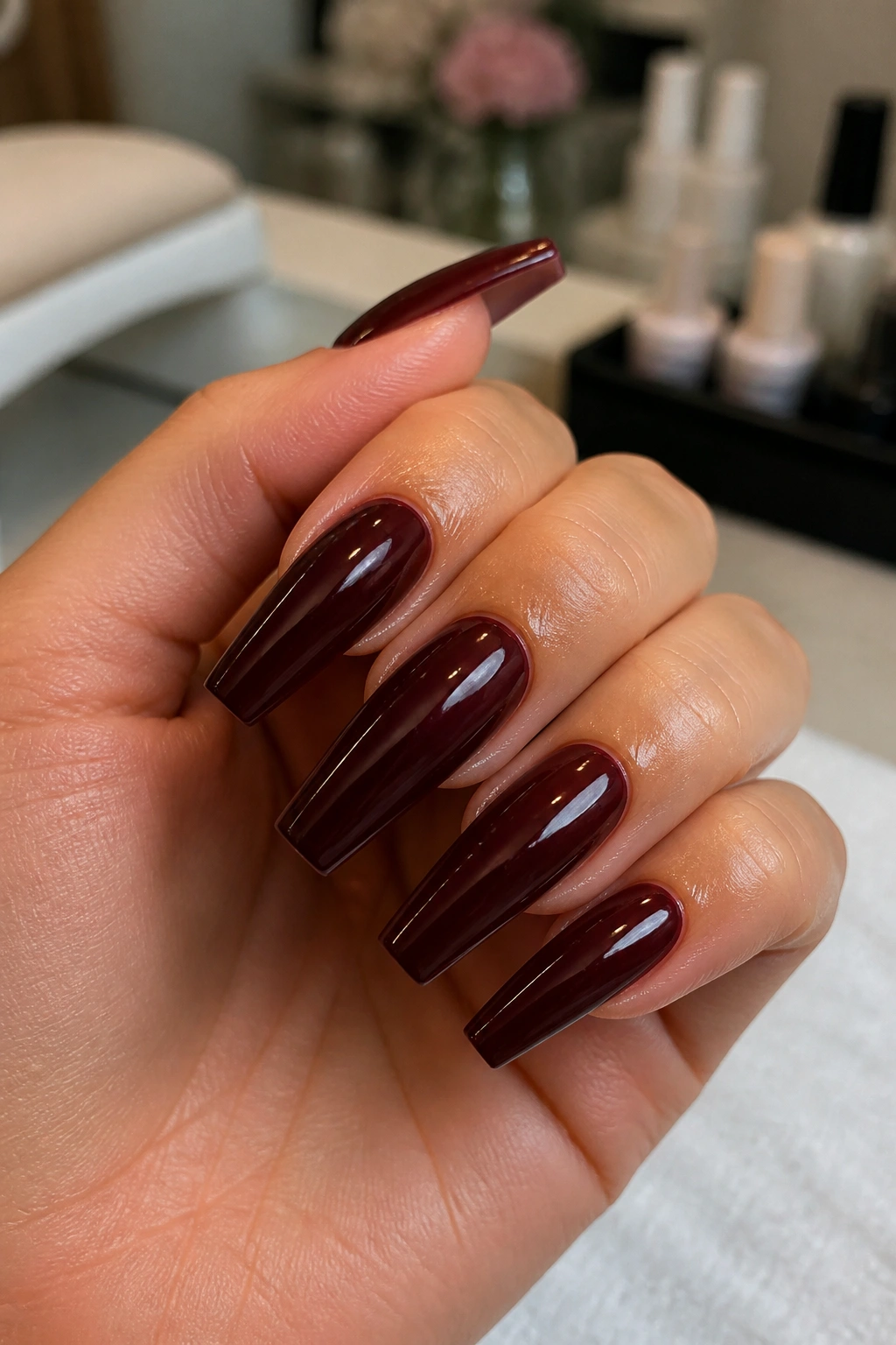 Close-up of dark coffin nails with crisp taper on a real hand