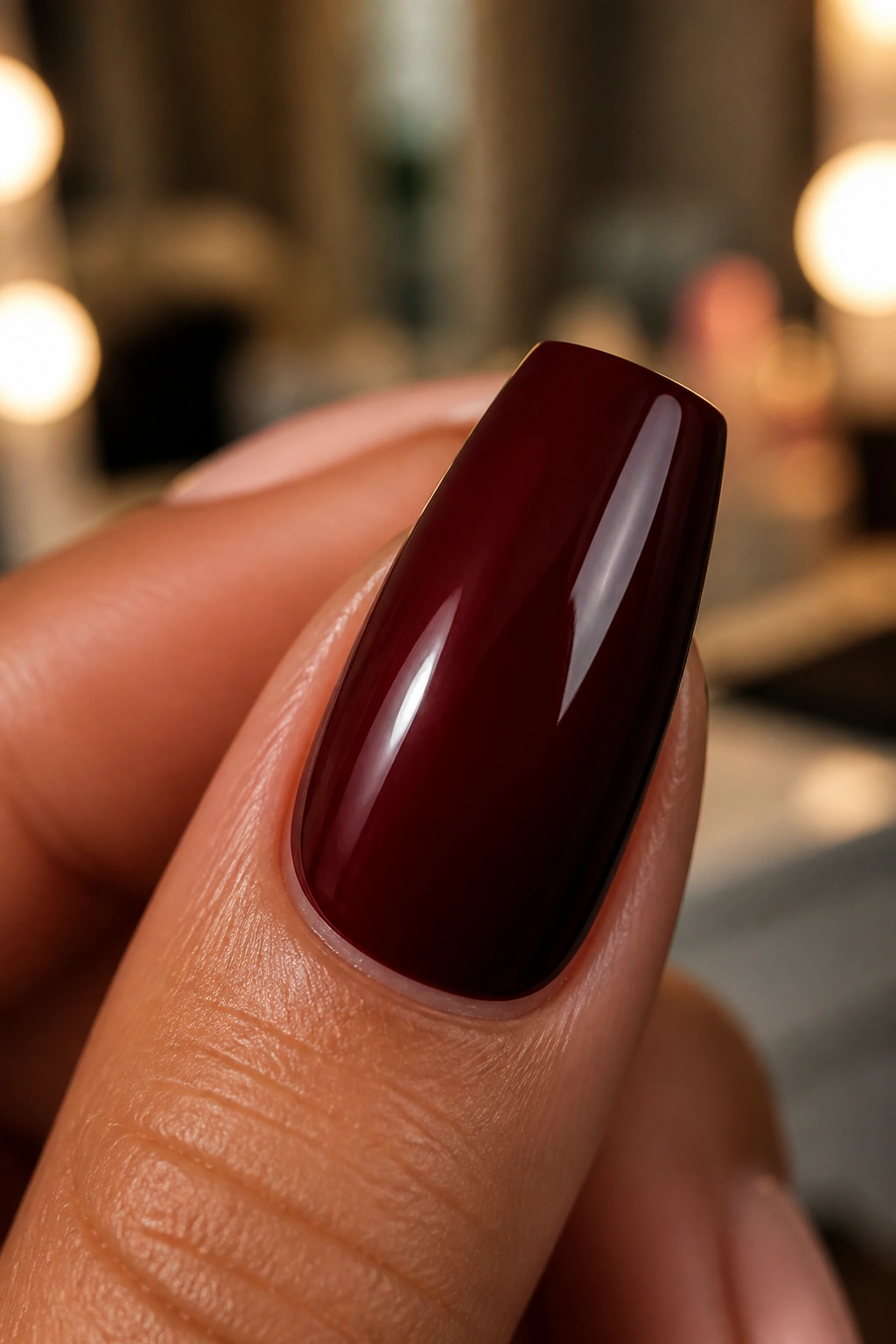 Close-up of a coffin nail painted in a deep dark red shade