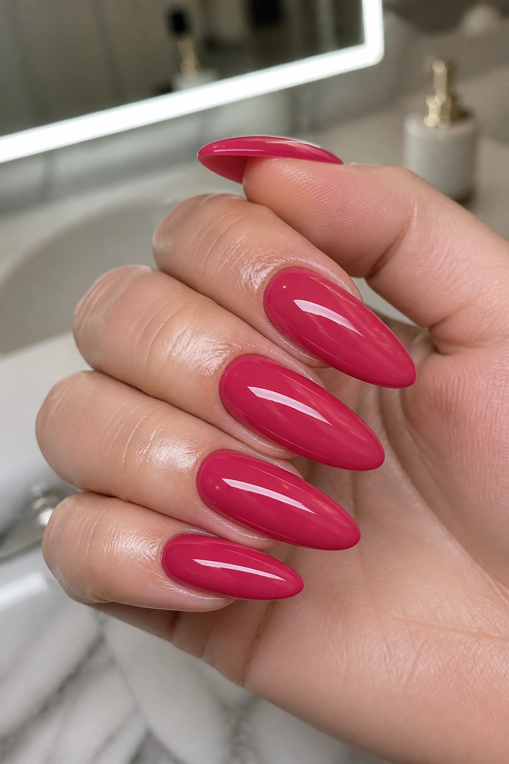 Close-up of deep rose nails with ultra-shiny top coat