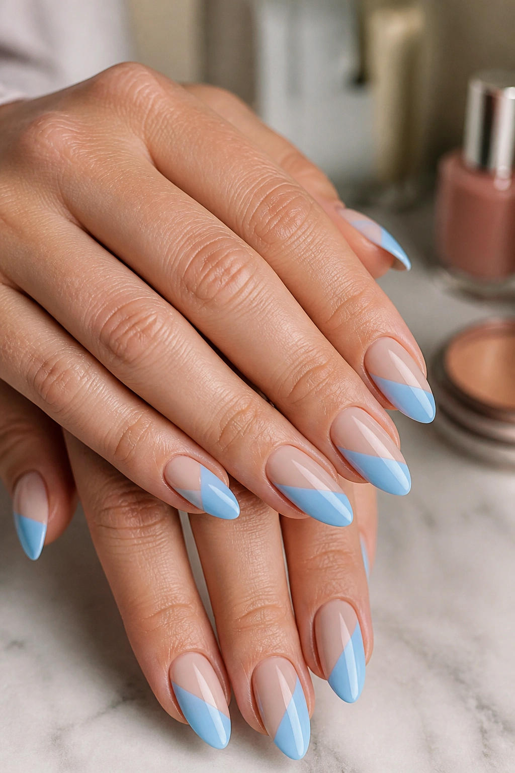 Almond nails with diagonal blue and nude color blocks