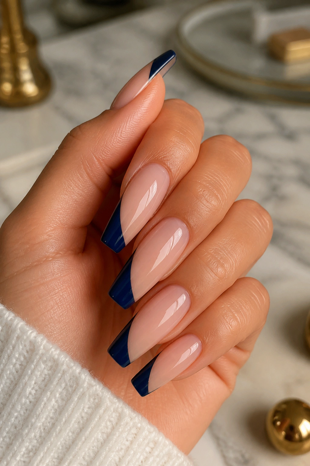 Close-up of diagonal navy side-French on coffin nails