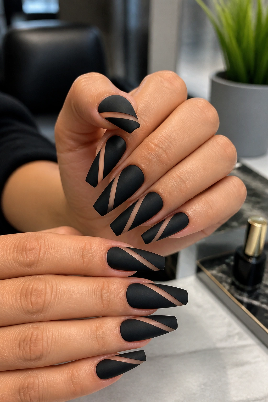 Matte black coffin nails with diagonal nude slash.