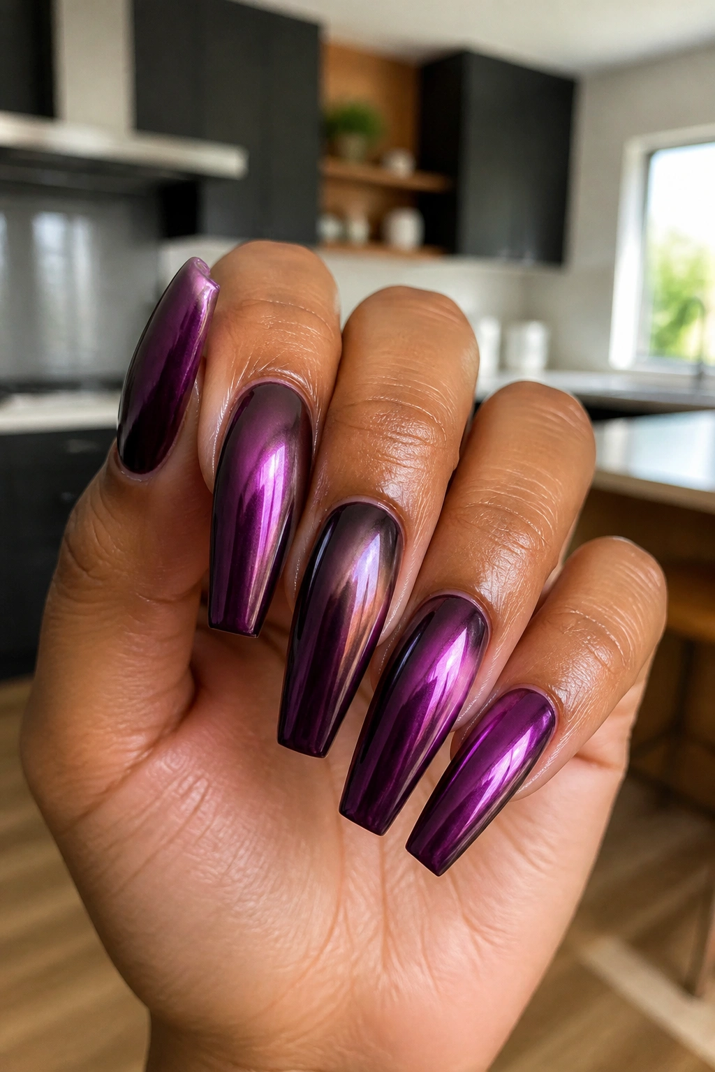 Close-up of eggplant chrome coffin nails on real hand