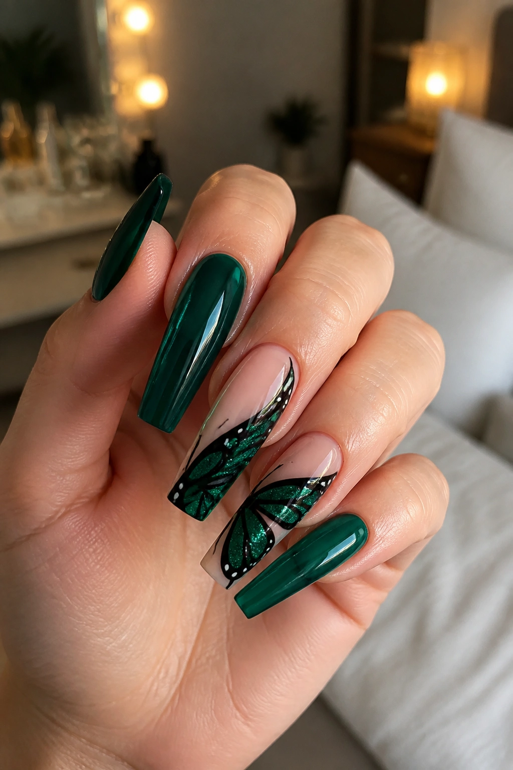 Close-up of emerald butterfly coffin nails with black wing details on a real hand