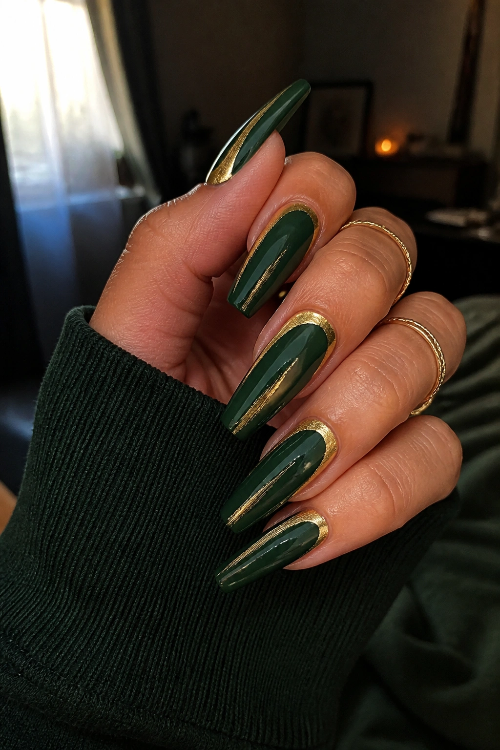 Close-up emerald green coffin nails with brushed gold accents